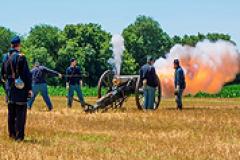 Union soldier reenactors firing a canon Union soldier reenactors firing a canon
