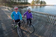 Two Bicyclists Stop to Take in the Water View Two Bicyclists Stop to Take in the Water View