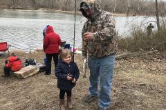 youth fishing rodeo girl catching a fish