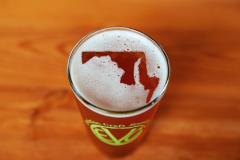 Glass of Evolution Craft Beer - foam forms Maryland map Glass of Evolution Craft Beer with foam that forms Maryland map