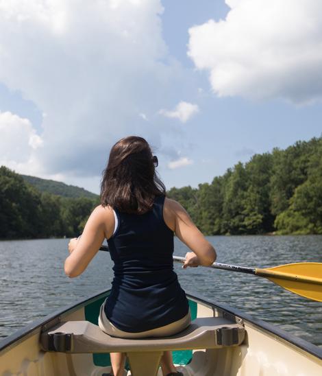 A woman rowing in a lovely lake
