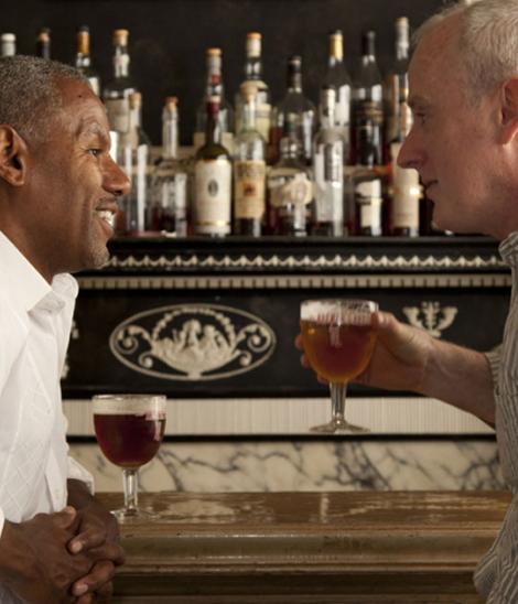 men drinking beer at bar