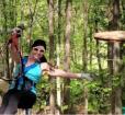Young lady ziplining through the forest Photo