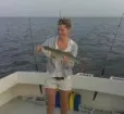 Angler proudly holding catch aboard Carlton Edwards Charter Photo