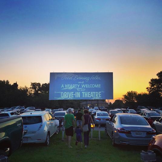 People relaxing in their cars watching a movie at the Bengies Drive-In Theater