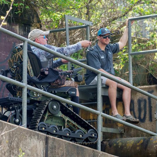 Man fishing using all-terrain track chair