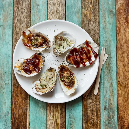 A plate of grilled oysters from Urban Oyster