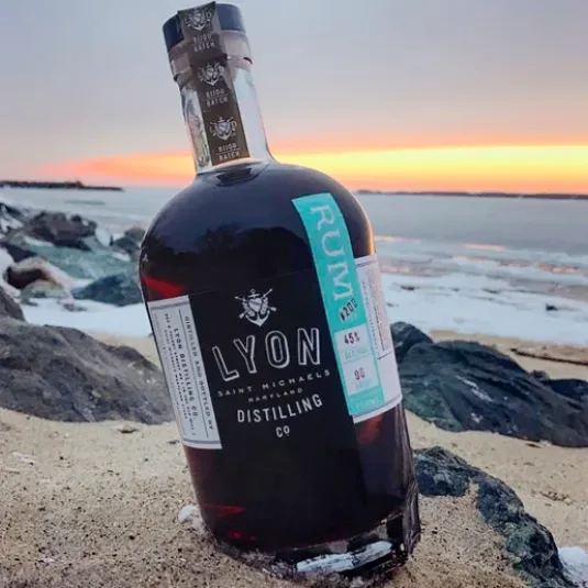 Bottle of Lyon Rum on a beach
