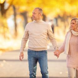 Couple walking along path on a fall day. Photo