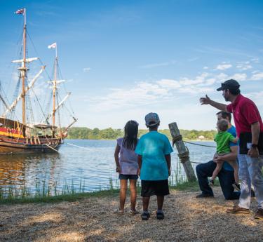 Family admires the Maryland Dove at St. Mary's City