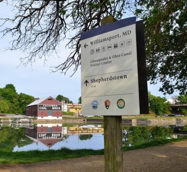 Visitor Center Sign for C and O Canal with Cushwa's Historic Warehouse in Background
