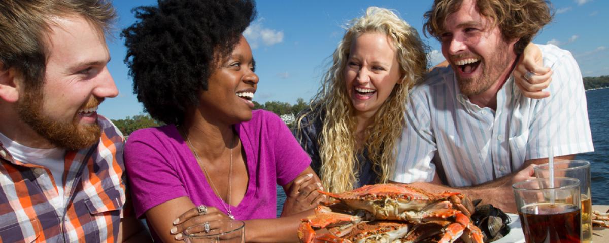 Enjoying steamed crabs in Annapolis couples laughing over crabs