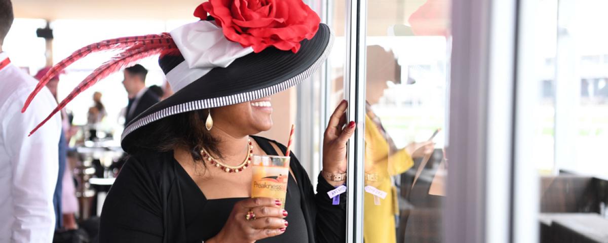 Enjoying a Black-Eyed Susan at the Preakness Stakes Enjoying a Black-Eyed Susan during the Preakness Stakes