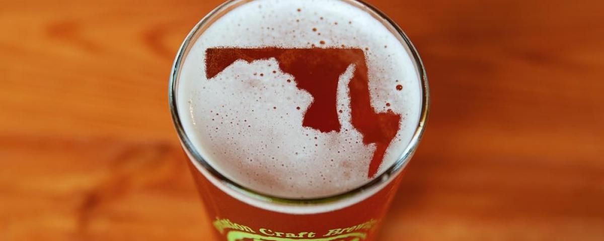 Glass of Evolution Craft Beer - foam forms Maryland map Glass of Evolution Craft Beer with foam that forms Maryland map